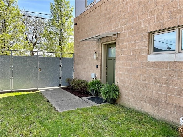 view of side of home with a yard