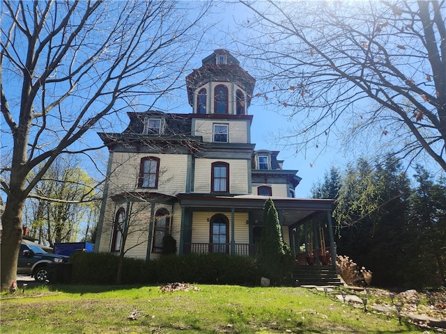 view of front of home with a porch and a front lawn