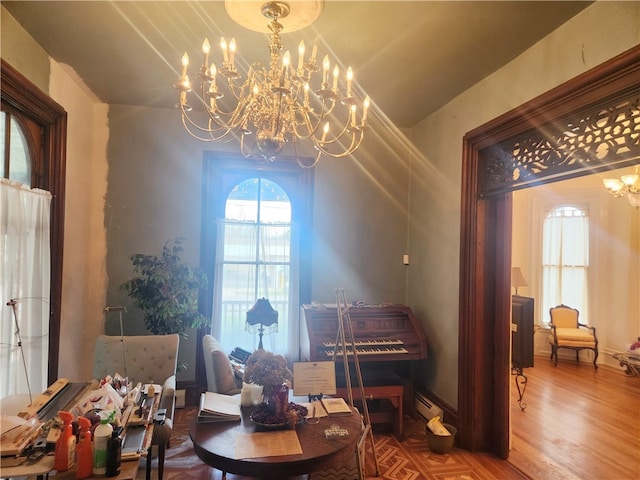 living area with hardwood / wood-style floors and an inviting chandelier