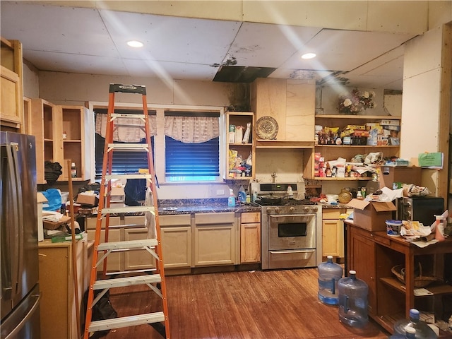 kitchen with wood-type flooring, a drop ceiling, stainless steel appliances, and light brown cabinetry