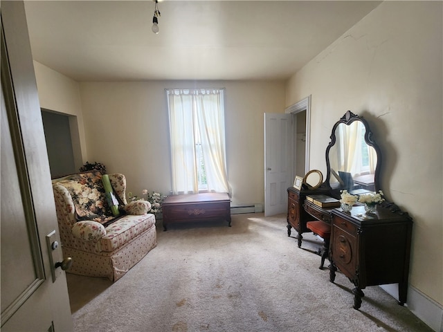 sitting room featuring carpet and a baseboard heating unit