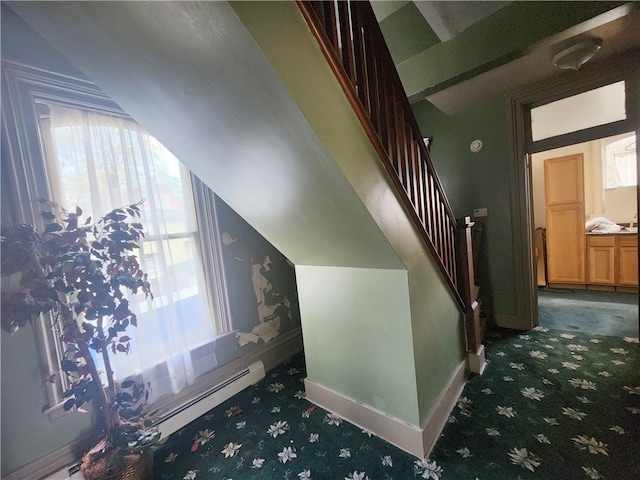 staircase featuring dark colored carpet and a baseboard radiator