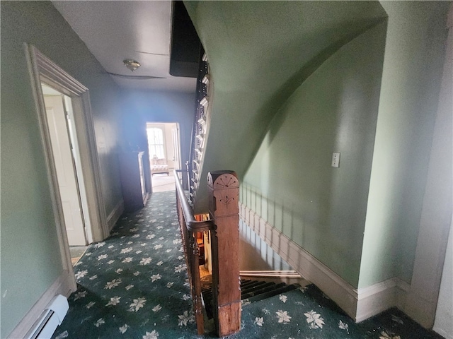 stairs featuring carpet and a baseboard heating unit