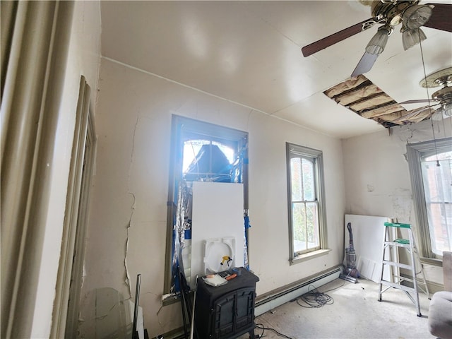 misc room with ceiling fan and a baseboard heating unit