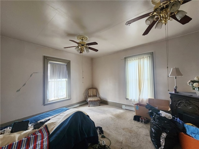 carpeted bedroom featuring a baseboard radiator, a wood stove, and ceiling fan