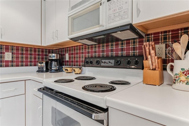 kitchen with white cabinets, tasteful backsplash, and white appliances