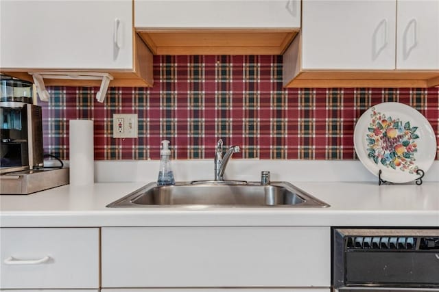 kitchen featuring white cabinetry, sink, backsplash, and dishwashing machine