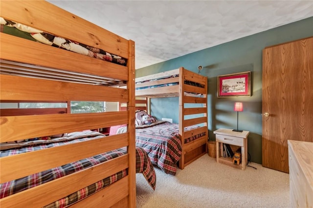 carpeted bedroom featuring a textured ceiling