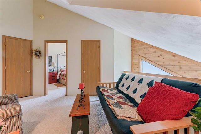 carpeted living room with high vaulted ceiling and wooden walls