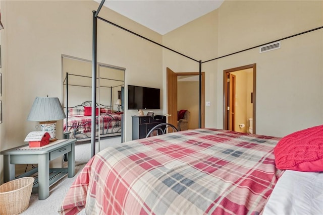 carpeted bedroom with a closet and vaulted ceiling