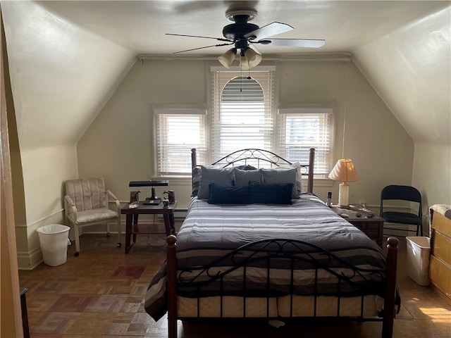 bedroom with lofted ceiling, multiple windows, and ceiling fan