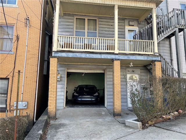 exterior space with a garage and a balcony