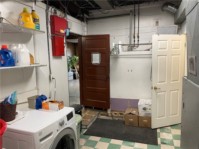 clothes washing area featuring washer / clothes dryer and tile flooring