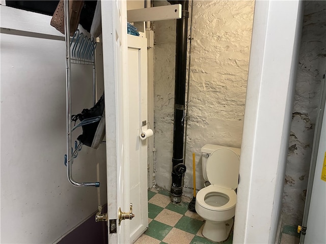 bathroom featuring toilet and tile floors