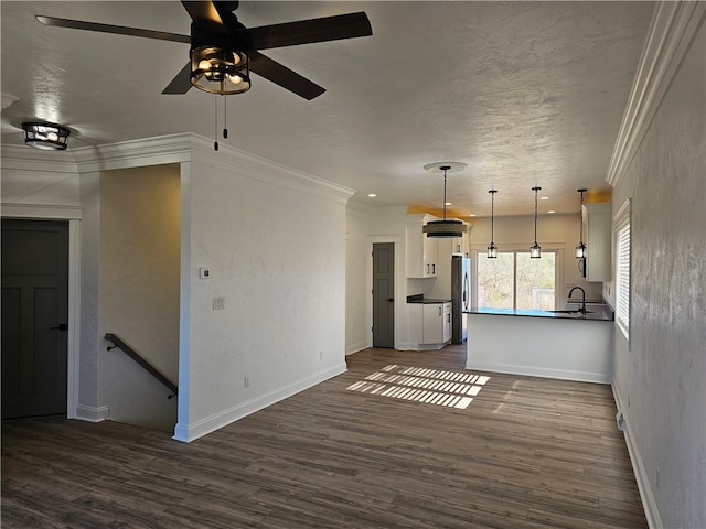 kitchen with white cabinets, dark wood-type flooring, and decorative light fixtures