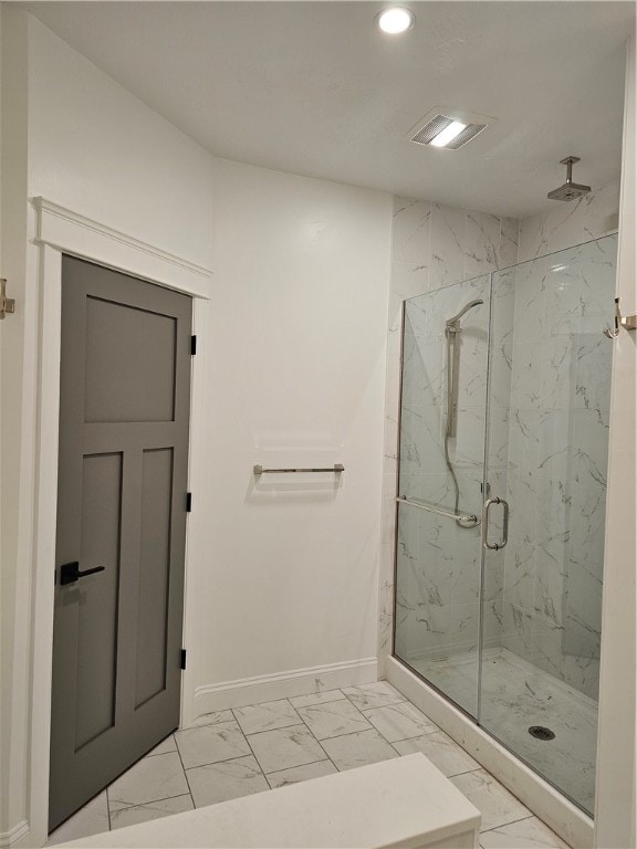 bathroom with a shower with door