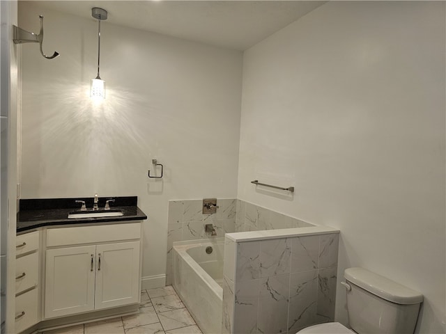 bathroom with vanity, toilet, and tiled tub