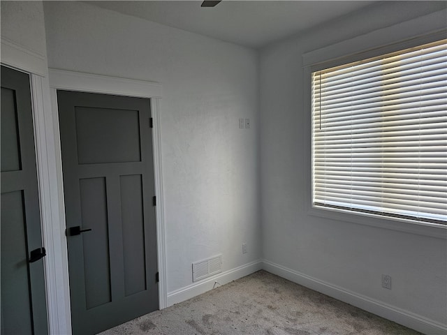 unfurnished room with light carpet