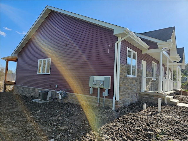 view of side of home featuring central AC unit and a porch