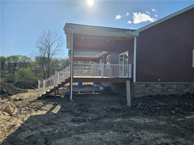 view of property exterior featuring a wooden deck