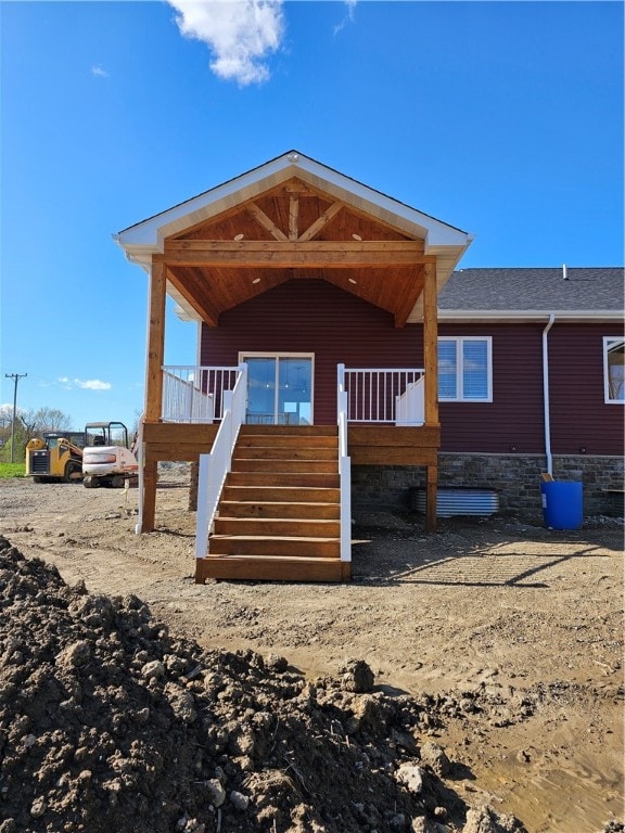 rear view of house with a wooden deck