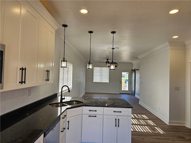 kitchen featuring dark stone counters, sink, and white cabinets