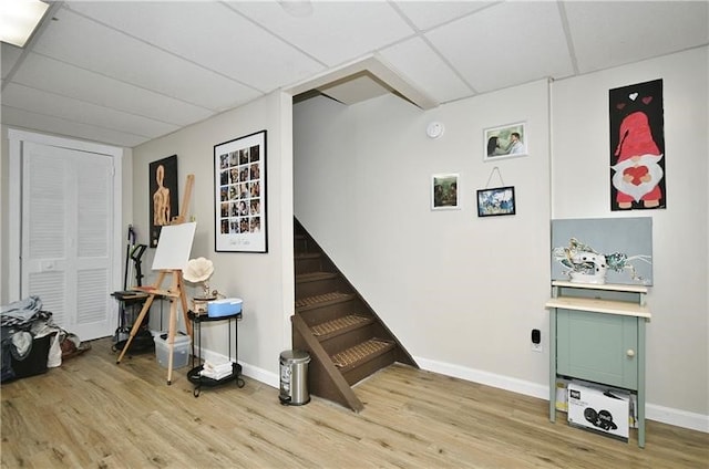 miscellaneous room featuring a drop ceiling and light wood-type flooring