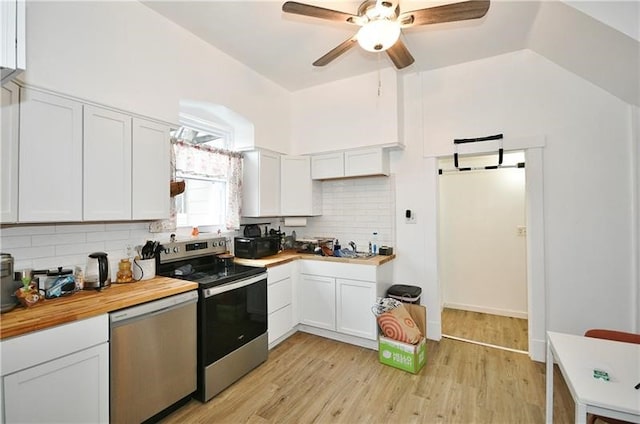 kitchen with light hardwood / wood-style flooring, white cabinetry, appliances with stainless steel finishes, tasteful backsplash, and ceiling fan