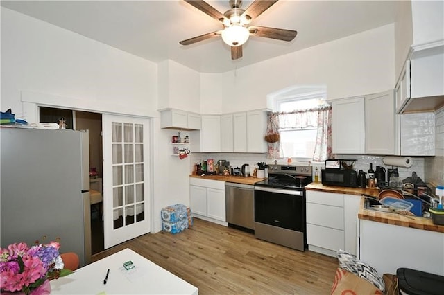 kitchen with ceiling fan, backsplash, white cabinetry, and stainless steel appliances