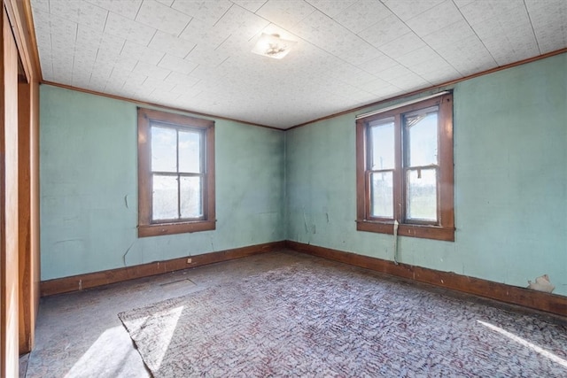 unfurnished room featuring crown molding