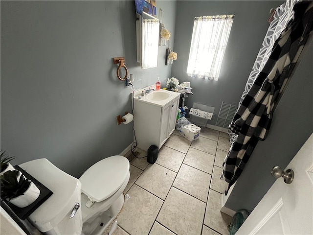 bathroom featuring toilet, tile floors, and vanity