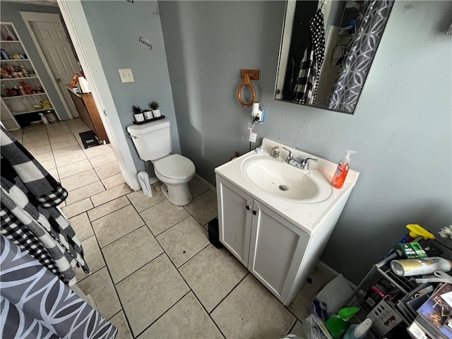 bathroom with tile flooring, vanity, and toilet