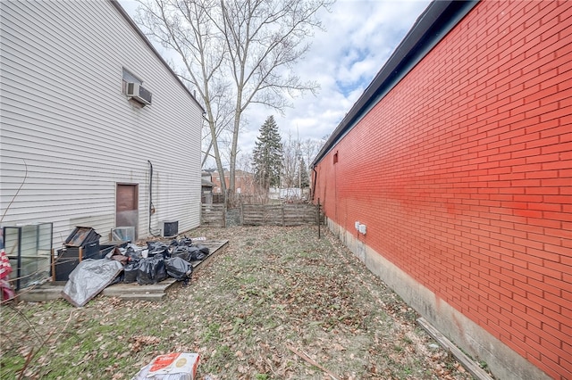 view of yard featuring an AC wall unit