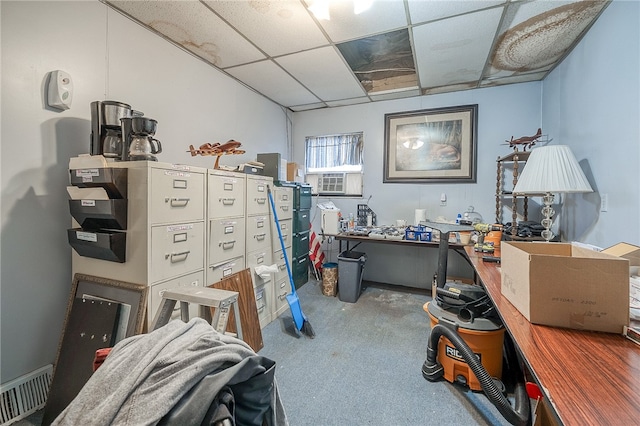 carpeted home office featuring a drop ceiling