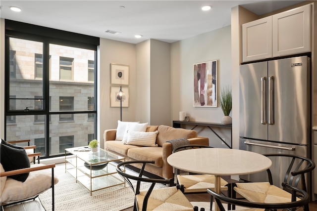 living room with a healthy amount of sunlight and light hardwood / wood-style floors