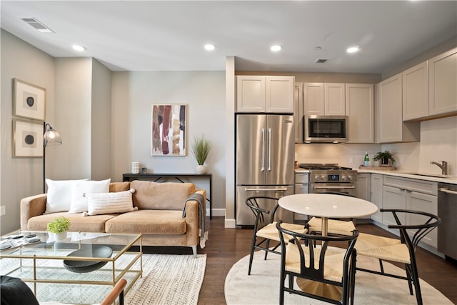 kitchen with dark hardwood / wood-style floors, sink, stainless steel appliances, and gray cabinets