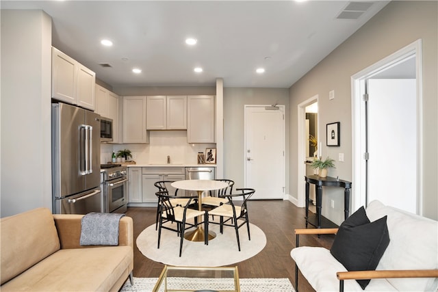 interior space with appliances with stainless steel finishes, sink, and dark wood-type flooring