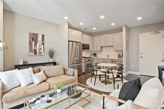 living room featuring dark hardwood / wood-style floors and sink