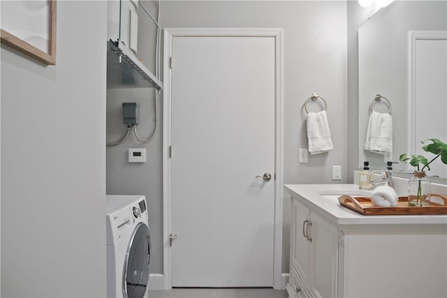 washroom with sink and washer / dryer