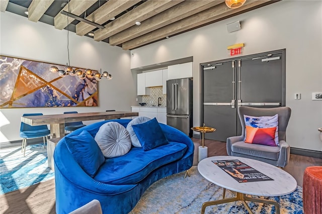 living room featuring beamed ceiling and wood-type flooring