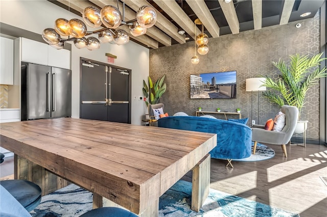 dining area with light hardwood / wood-style floors and beam ceiling