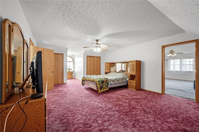 bedroom with a textured ceiling, carpet flooring, and ceiling fan