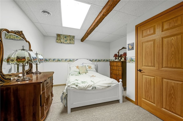 bedroom featuring carpet and a drop ceiling