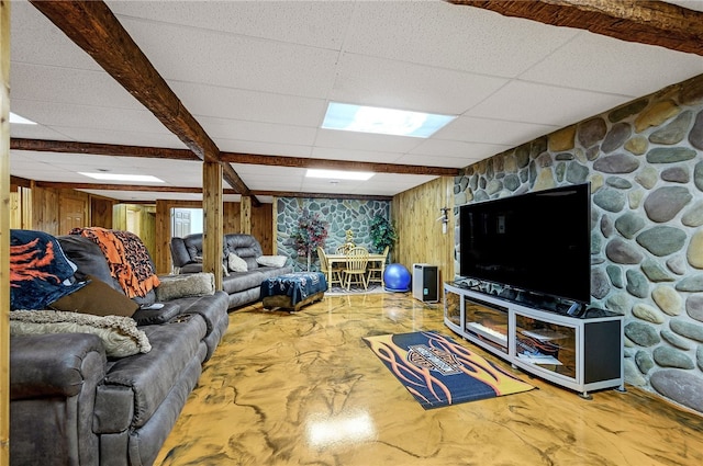 living room with wooden walls and a paneled ceiling