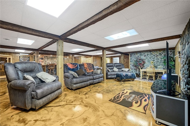 living room with beam ceiling and wooden walls