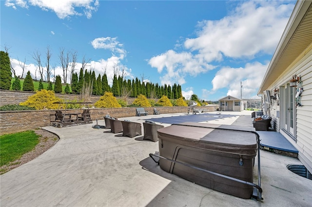 view of terrace with a hot tub