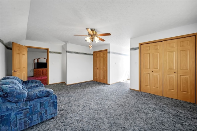 unfurnished living room with carpet, ceiling fan, and a textured ceiling