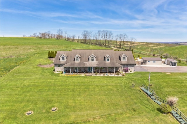 exterior space featuring a rural view and a yard