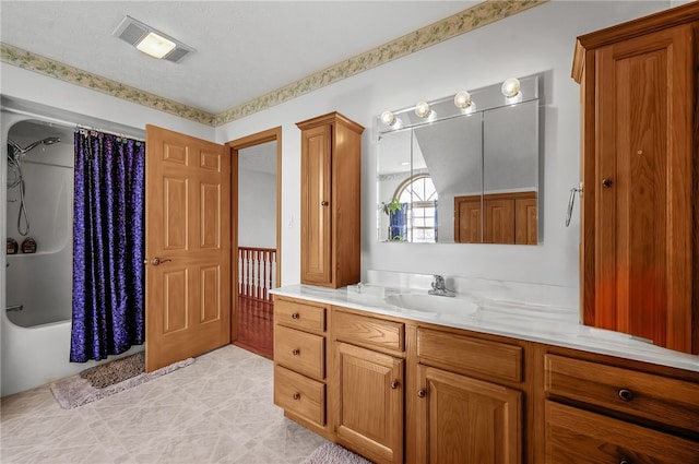 bathroom featuring tile flooring, vanity, a textured ceiling, and shower / bath combo with shower curtain