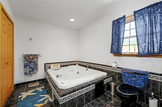 bathroom featuring tile flooring and tiled bath